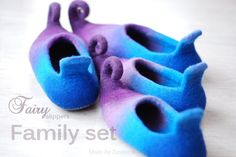 two blue and purple slippers sitting on top of a table