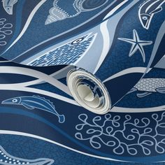 a blue and white wallpaper with an abstract design on the bottom half of it