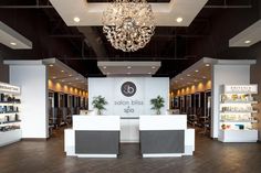 the salon bliss spa is located in an upscale building with wood floors and chandelier