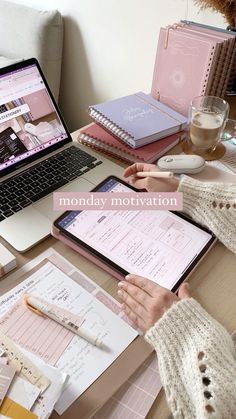 a person sitting at a desk with a laptop and papers on the table next to them