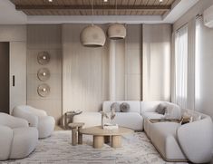 a living room filled with white furniture next to a wall mounted light above a coffee table