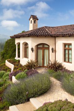 a house that has some plants in front of it