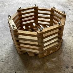 a close up of a wooden basket on the ground