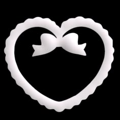 a white heart shaped object with two bows in it's center on a black background