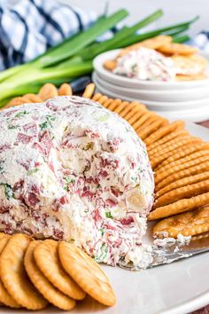 a cheese ball with crackers on the side