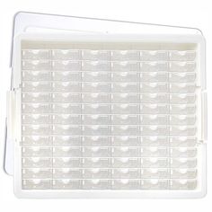 a white plastic tray filled with lots of clear drawers on top of a white surface