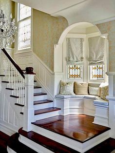 the stairs in this house are made of wood and have been painted white with gold trim