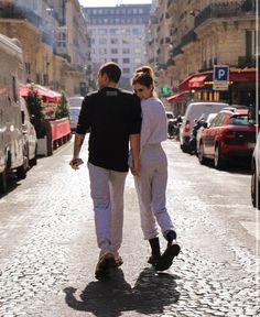 a man and woman are walking down the street