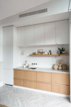 a kitchen with wooden cabinets and white walls