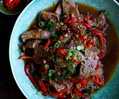 a blue plate topped with meat and veggies