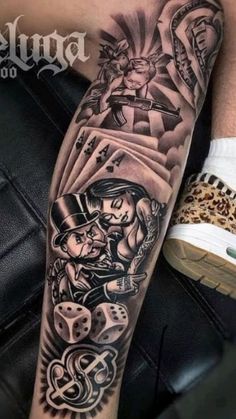 a man's leg with tattoos on it and some dice in the foreground