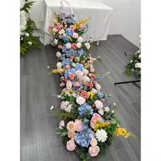 an arrangement of flowers is arranged on the floor