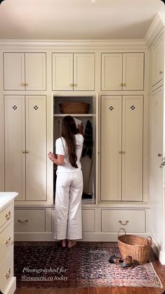 a woman standing in front of a white closet