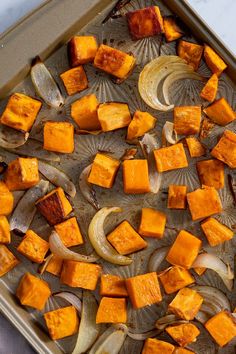 a pan filled with sweet potatoes and onions