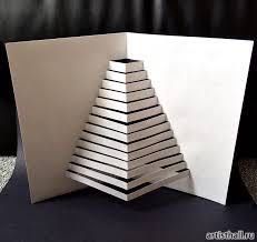 an origami christmas tree made out of white paper