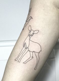 a tattoo on the arm of a person with a deer