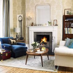 a living room filled with furniture and a fire place in the middle of a room