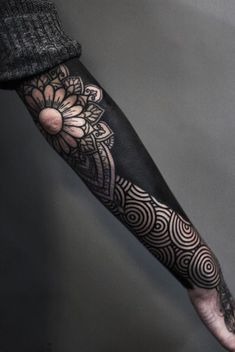 a person with a black and white tattoo on their arm