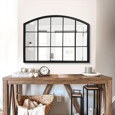 a wooden table topped with a mirror next to a wall