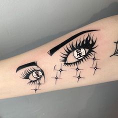 a woman's arm with an eyeball and stars tattoo on the left forearm