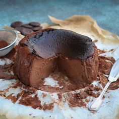 a chocolate cake sitting on top of a white plate