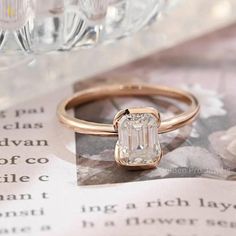 a close up of a ring on top of a book