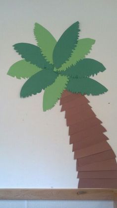 a paper palm tree cut out on the wall