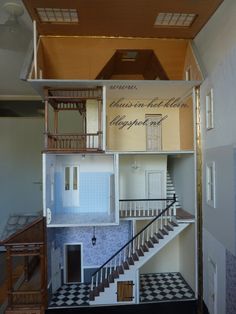 the inside of a doll house with stairs