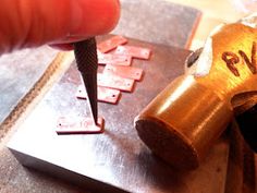 a person using a drill to cut wood letters on a piece of plywood board