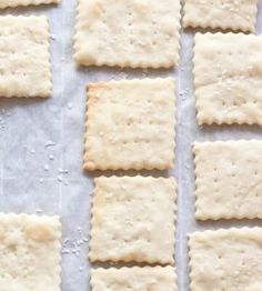 crackers are lined up on a baking sheet and ready to go into the oven