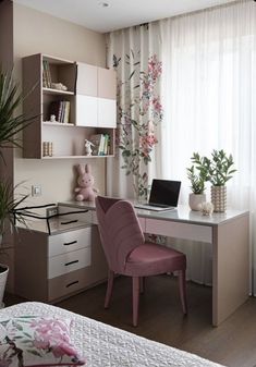 a bedroom with a bed, desk and chair next to a window covered in curtains