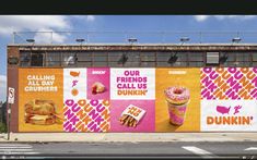 an advertisement for dunkin donuts on the side of a building