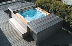 a hot tub sitting on top of a wooden deck