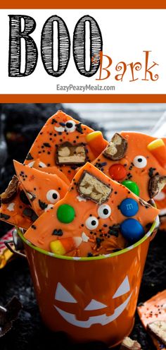 an orange bowl filled with halloween treats and the words boo bank on top of it