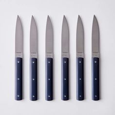 five knives are lined up in a row