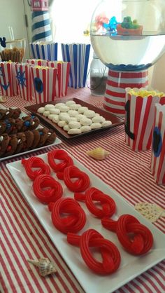 red, white and blue desserts are on the table at a carnival themed birthday party