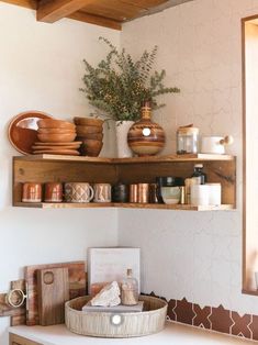 the shelves are filled with bowls, plates and utensils on top of each other