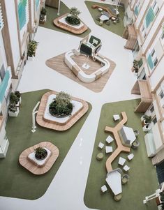 an aerial view of a courtyard with seating and plants