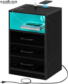 an electronic device is plugged in to a black filing cabinet with three drawers on each side