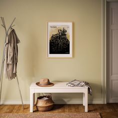 a white bench sitting in front of a wall with a poster on it's side