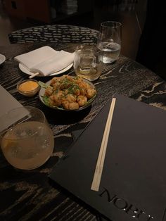 a table topped with plates and glasses filled with food