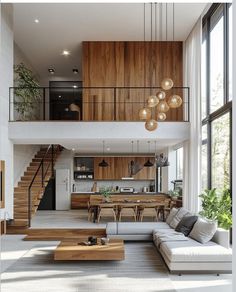 a living room filled with lots of furniture next to a stair case in front of a window