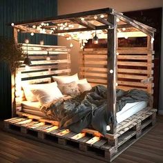 a bed made out of wooden pallets with lights on top and pillows in the middle