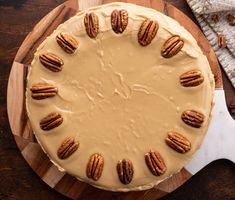 there is a pie with pecans on the top and frosting in the middle