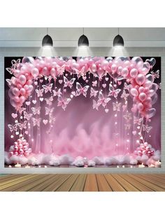 an image of a stage set up with balloons and flowers on the stage for a show