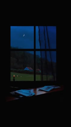 an open window with a view of the night sky