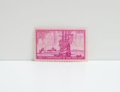 a pink stamp with a ship on it