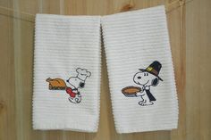 two white towels with cartoon characters on them