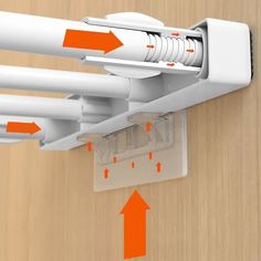 an orange and white object is attached to a wooden wall with arrows pointing up at it