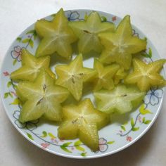 star shaped fruit on a plate with flowers